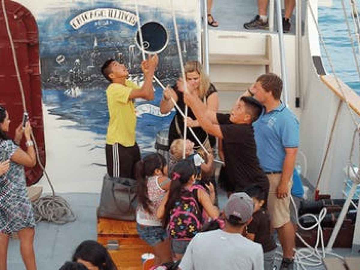 Sail tour participants on the deck of Tall Ship Windy