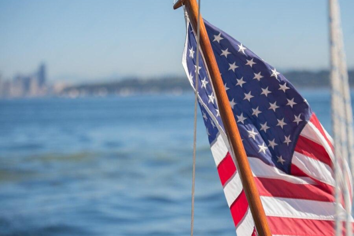 a flag next to a body of water